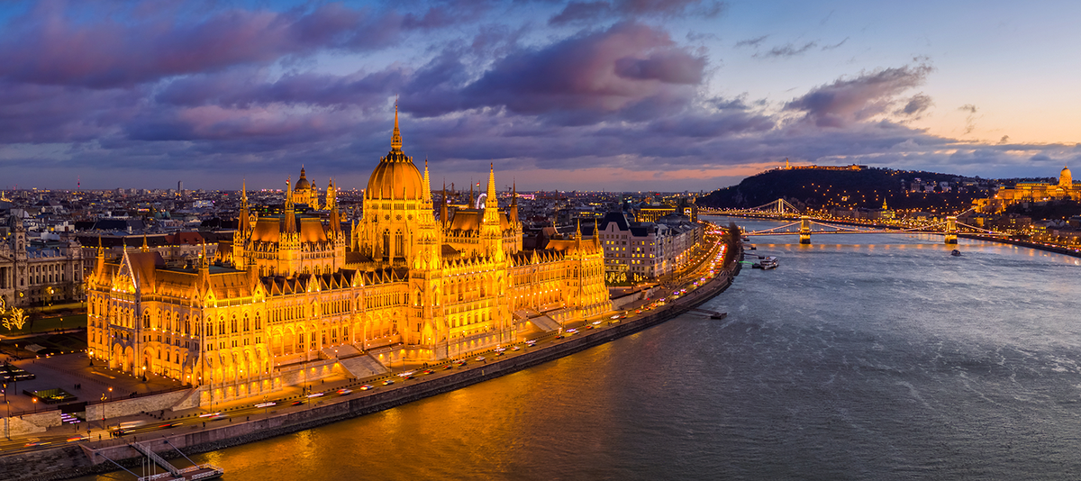 Das Parlamentsgebäude in Budapest an der Donau bei abendlicher Dämmerung und Beleuchtung