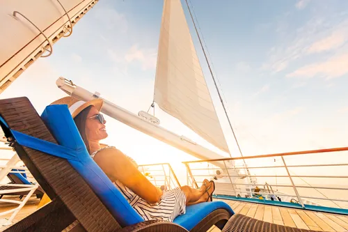 Eine frau liegt in einem Deckchair auf einem Kreuzfahrtschiff